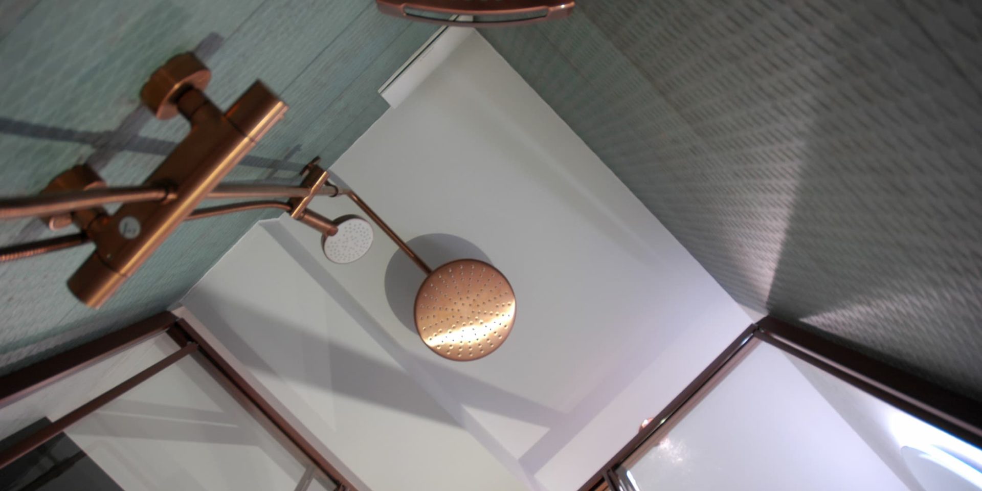 Die türkisfarbenen Wandfliesen passen perfekt zu den kupferfarbene Armaturen